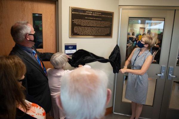 President Laua Casamento and Provost Todd Pfannestiel reveal a plaque during a dedication ceremony of the Wilcox Center on September 08, 2021.